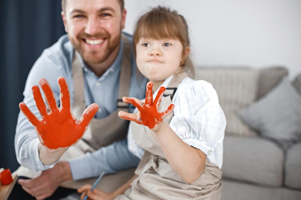 girl-with-down-syndrome-her-father-painted-hands-red-colour